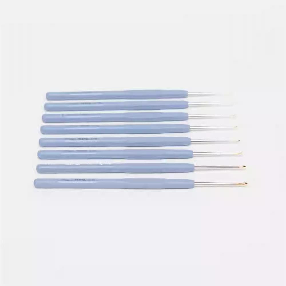 A set of six crochet hooks in various shades of blue, arranged in a row.