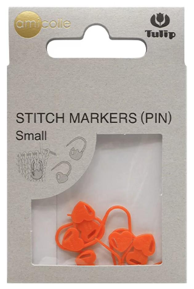 a package of small orange sewing markers, also known as pins, with a clear plastic window allowing a view of the markers inside.
