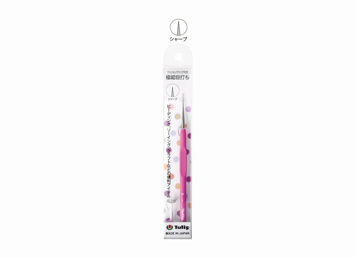 A pink and white pencil with a dotted pattern, packaged in a Japanese-language cardboard box.