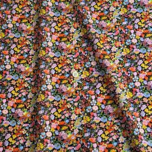 a close-up view of a fabric with a vibrant floral pattern. The fabric appears to be a dark-colored material with a variety of colorful flowers and leaves, creating a visually striking and lively design.