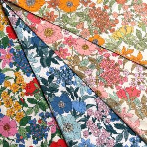 The image is a collage of various colorful fabric swatches, each featuring a different floral pattern. The swatches display a range of vibrant colors and intricate designs, creating a visually appealing and diverse collection.
