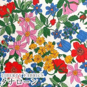 The image is a vibrant collage of various colorful flowers and leaves, including red, pink, yellow, blue, and green flowers, all set against a white background.