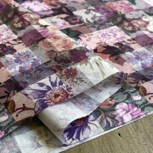 The image is a close-up of a fabric with a floral pattern, featuring a variety of colors and shapes.
