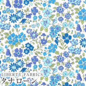 The image is a collage of various blue and white floral patterns, including daisies, pansies, and other flowers. The text "LIBERTY FABRICS" is visible, indicating the brand or type of the fabric.