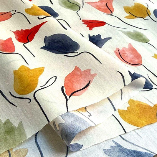 a close-up view of a fabric with a repeating pattern of colorful flowers, including red, yellow, and blue flowers.
