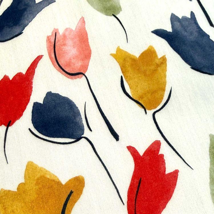 a close-up view of a white background with colorful flower-like shapes in various shades of red, yellow, and blue.