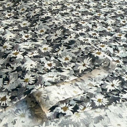 a close-up view of a fabric with a black and white floral pattern.