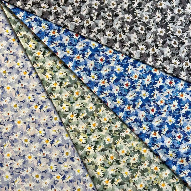 The image is a collage of various fabric swatches with different floral patterns, including white and yellow flowers, as well as a mix of blue, green, and gray floral designs.