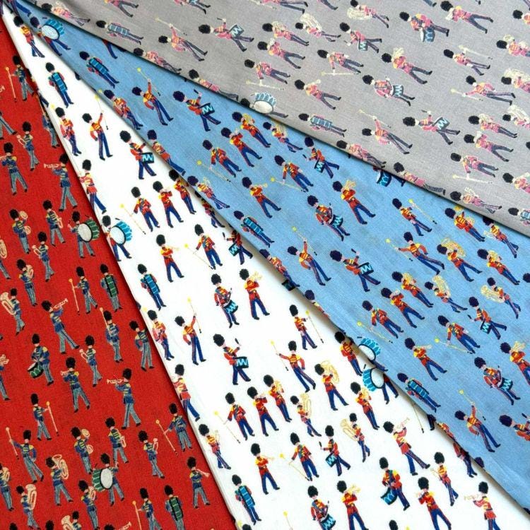 a collection of fabric swatches with various patterns and designs, including marching band motifs and other colorful patterns.