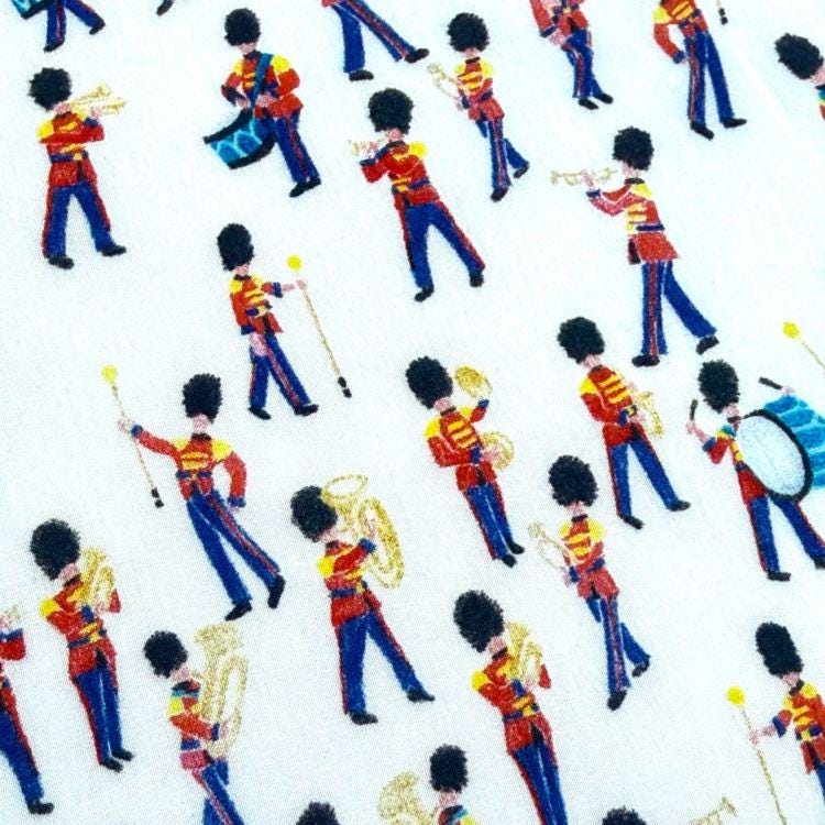 a pattern of soldiers in red and yellow uniforms marching in formation, playing various musical instruments such as drums, trumpets, and tubas.