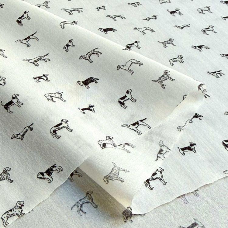 a repeating pattern of black and white dog illustrations on a white background.