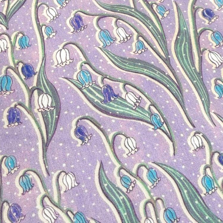 a repeating pattern of blue and white flowers on a purple background, creating a visually appealing and harmonious design.