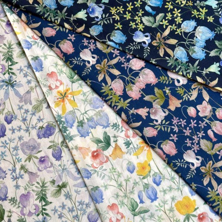 a collection of fabric swatches with various floral patterns, including blue, white, and yellow flowers.