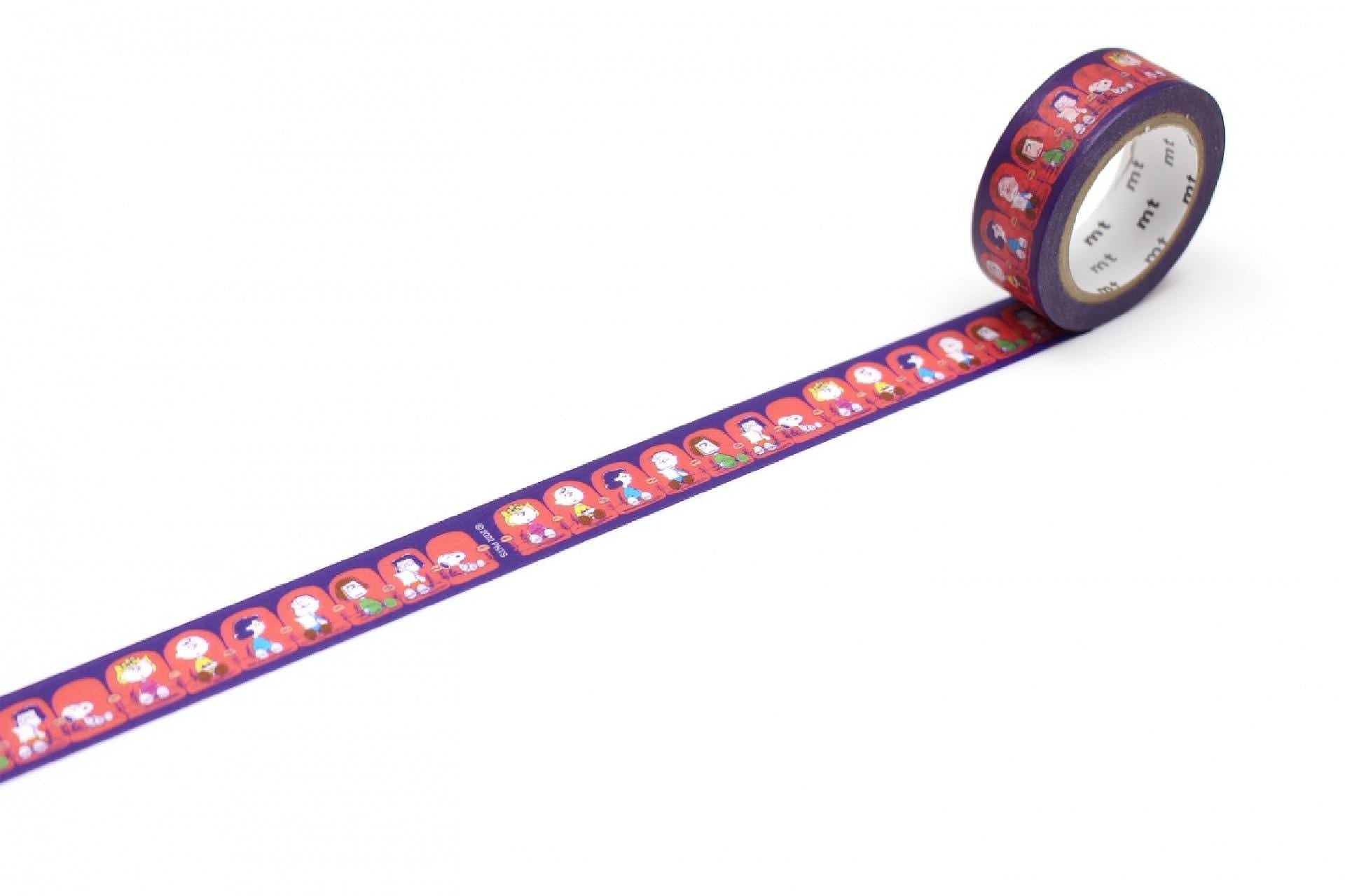 A roll of purple and red patterned tape with a repeating design of cartoon-like characters on it.