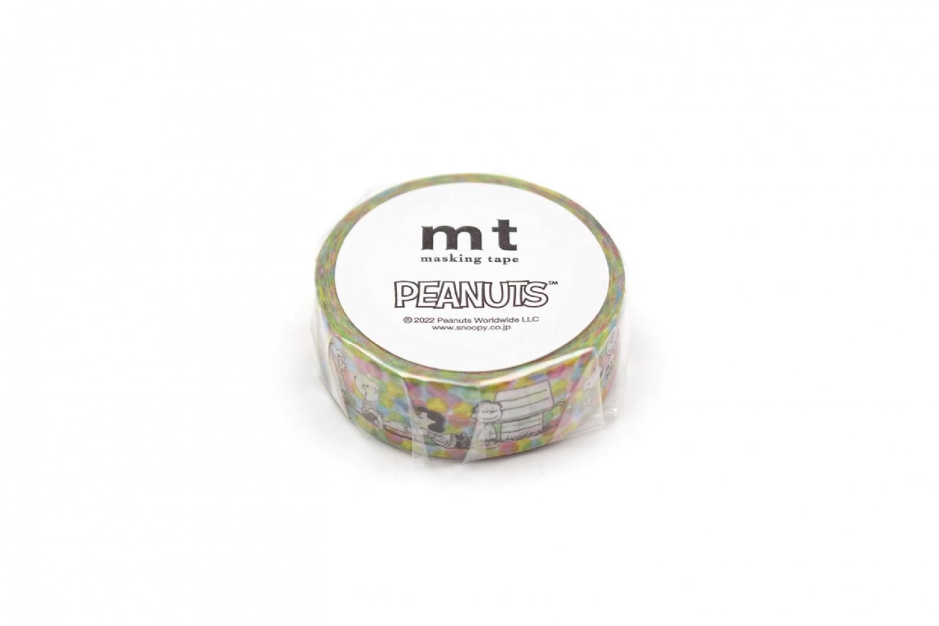 A round roll of Peanuts themed masking tape against a white background.