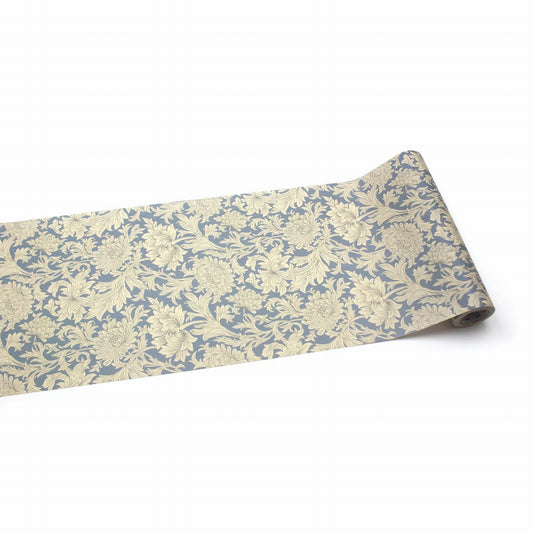 a roll of wallpaper with a floral pattern in shades of blue and beige.