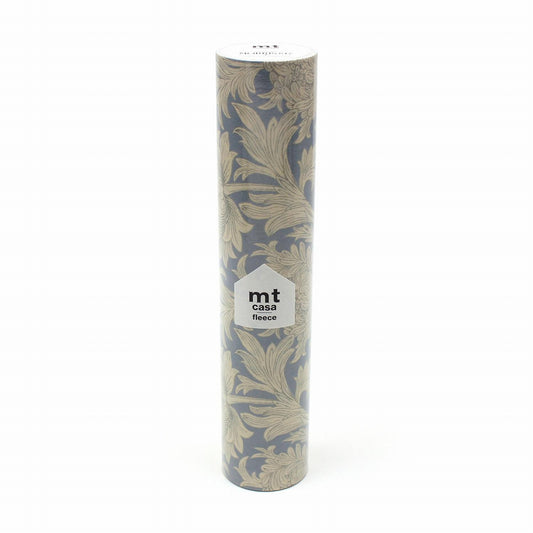 A tall, cylindrical object with a floral pattern on it, featuring a label with text.