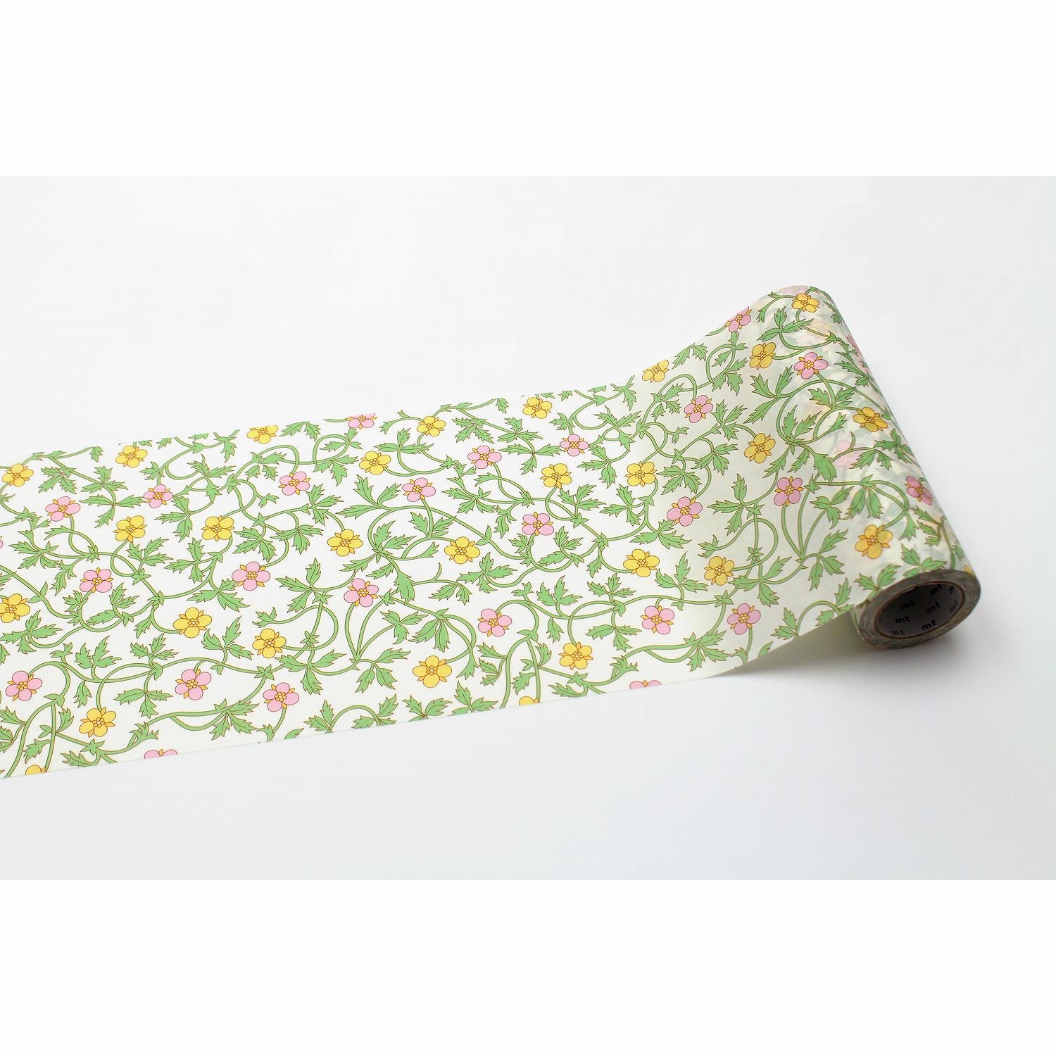 A roll of paper with a floral pattern of green leaves and yellow flowers.