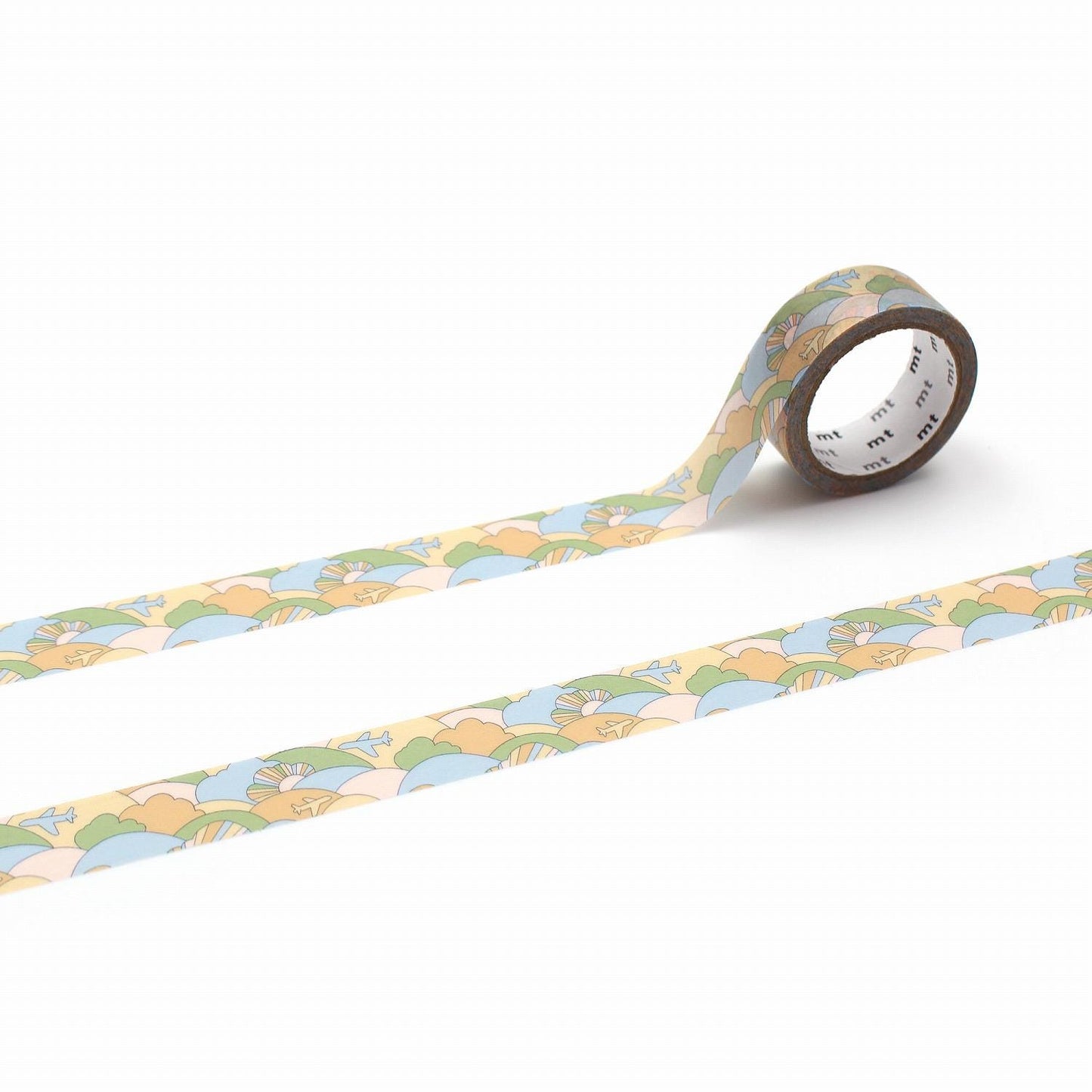 a roll of patterned tape with a repeating design of hills and clouds on it, lying on a white background.