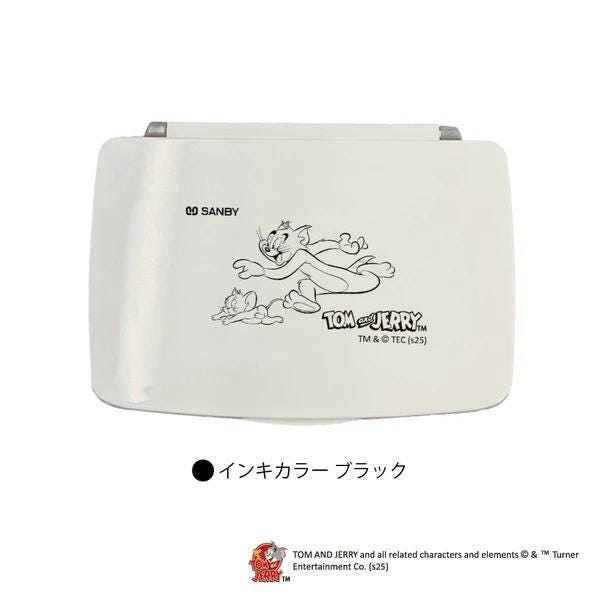 A white rectangular object with a cartoon image of two cats, one larger and one smaller, on it. The cats appear to be in motion, running or jumping. The object has a logo or text that reads "Tom and Jerry" and "TM & © (25)".