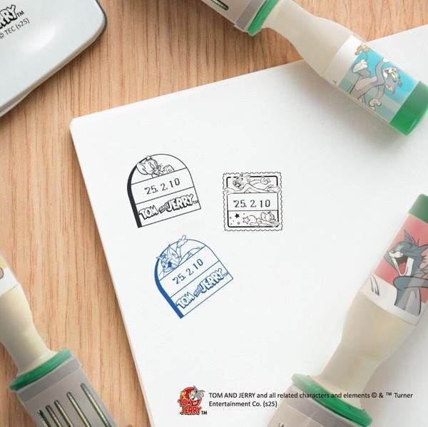 a collection of novelty items, including a stamp and a pen, with a focus on the cartoon character Tom and Jerry.