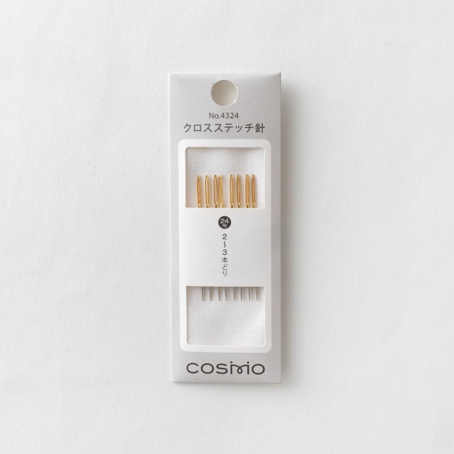 A package of knitting needles with gold tips, labeled as "No 4324" and "cosmo".