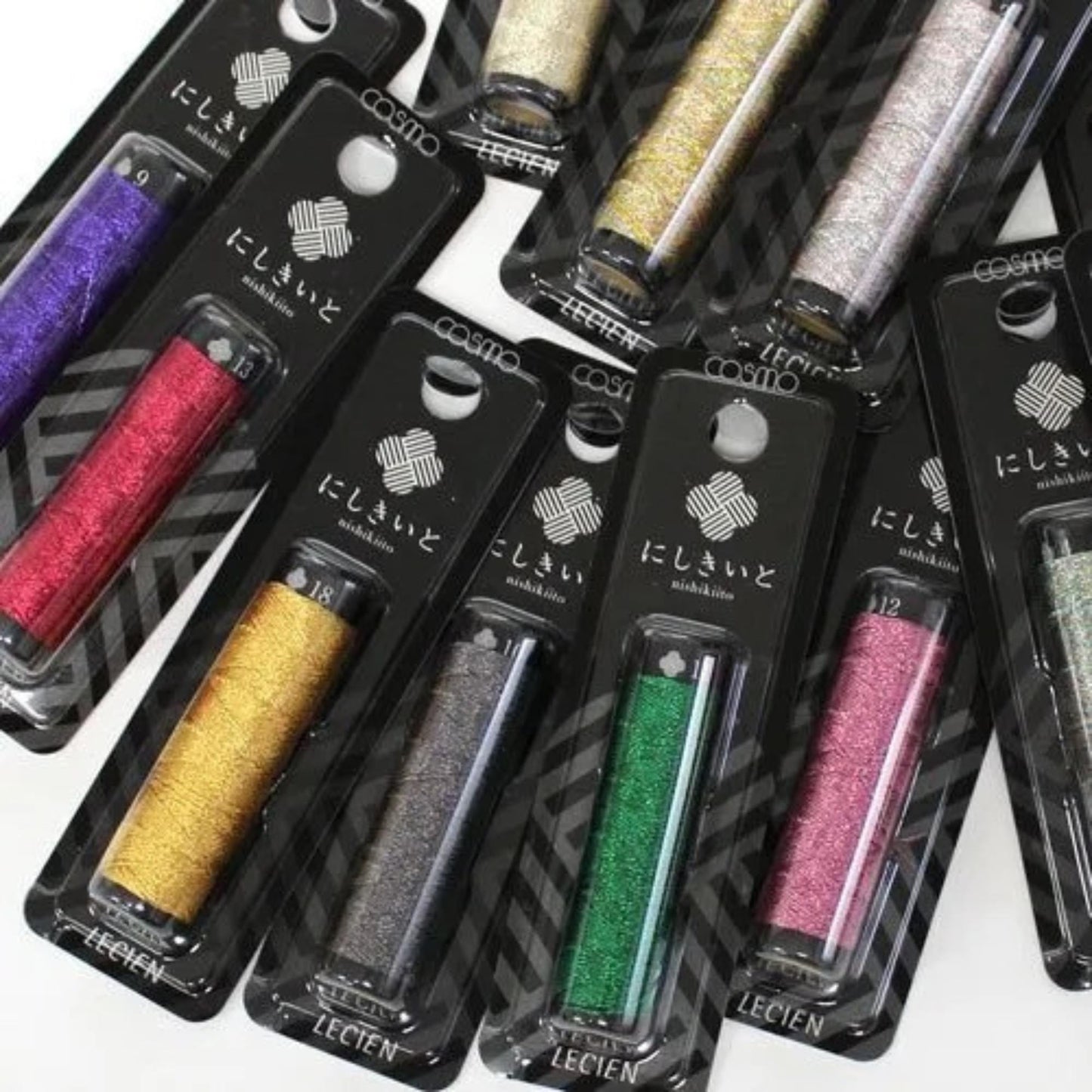 multiple packages of thread in various colors, including purple, red, gold, black, green, and pink.