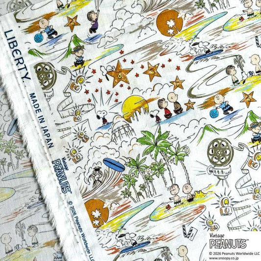 The image is a vibrant and colorful fabric print featuring various cartoon characters and scenes, including Peanuts characters, such as Charlie Brown, Snoopy, and Woodstock. The print is a collage of multiple images, creating a lively and dynamic visual experience.