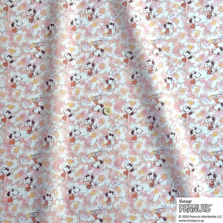 a repeating pattern of cartoon characters, specifically the Peanuts characters, on a fabric or material.