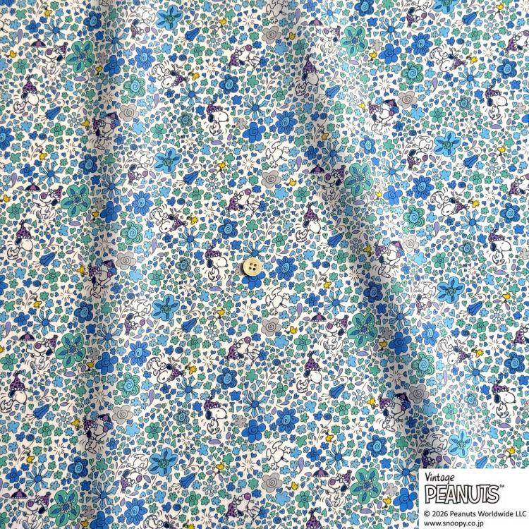 The image is a close-up of a fabric with a floral pattern in shades of blue, green, and white. The fabric appears to be a vintage Peanuts print, as indicated by the text "Vintage Peanuts" and "©2020 Peanuts Worldwide LLC".