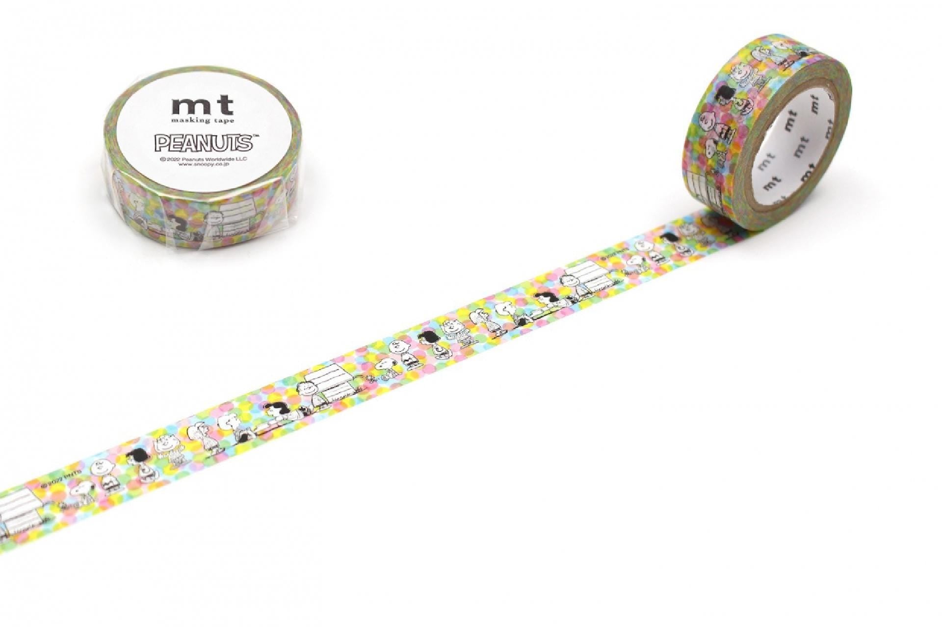 a roll of Peanuts themed tape and a roll of regular tape, both with colorful patterns.