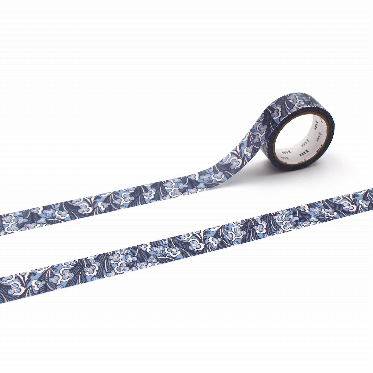 a roll of patterned tape with a blue and white floral design, lying on a white background.