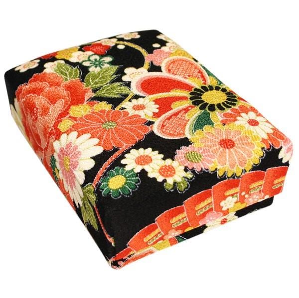 a black box with a vibrant floral pattern on it.