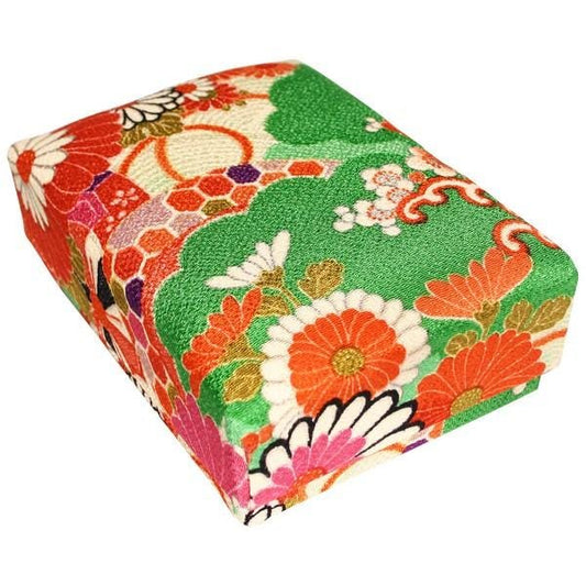 a colorful, patterned box with a floral design in shades of green, red, and orange.