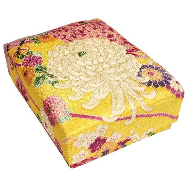 a square-shaped box with a vibrant, colorful floral pattern on its surface.