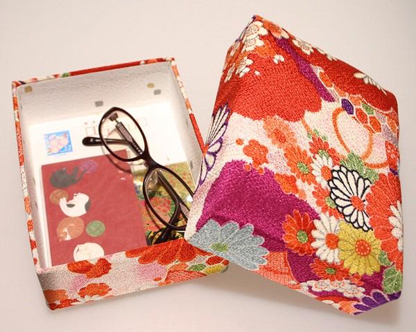a pair of glasses placed inside a colorful, floral-patterned box.