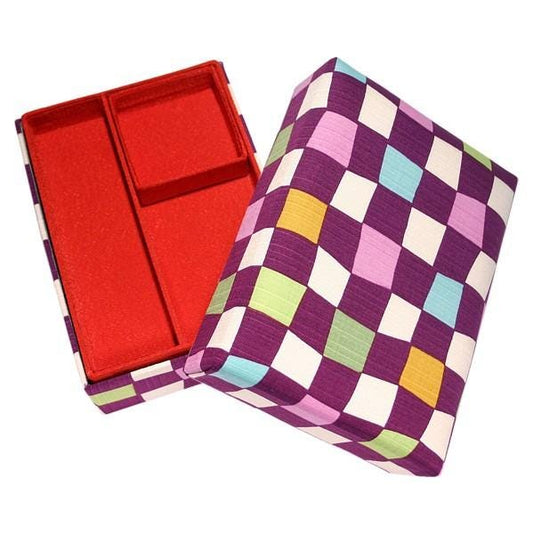 an open box with a red compartment and a colorful checkered pattern on the lid.