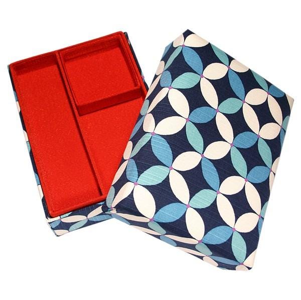 a red and blue patterned box with a red compartment, placed on a white background.
