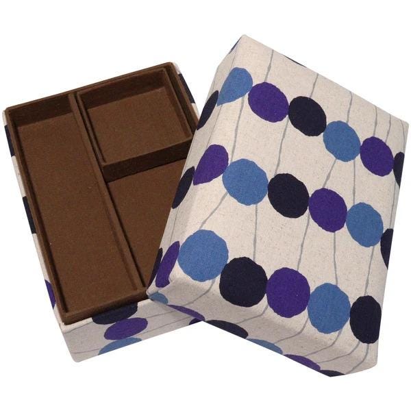 a brown and white box with a pattern of blue and purple circles on it.