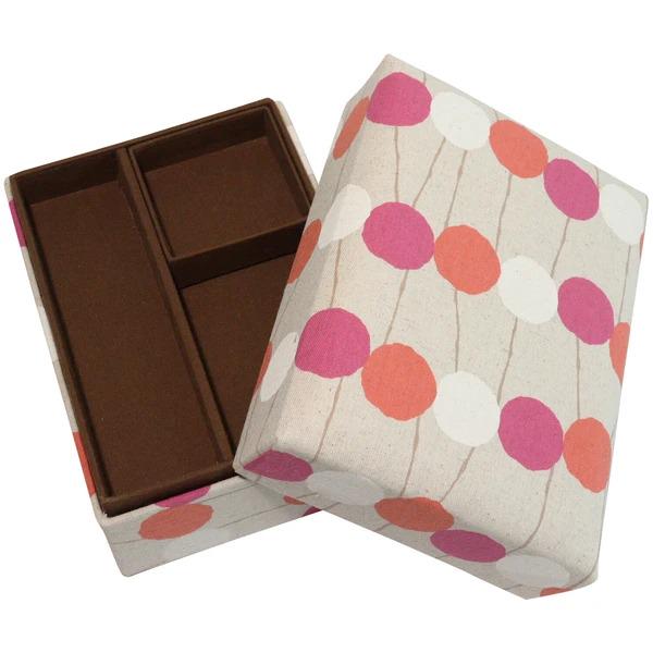 a box with a polka dot pattern on it, and the box is open, revealing a brown interior.