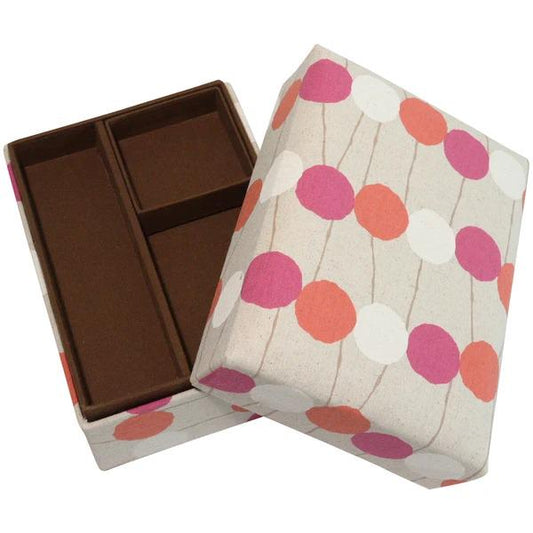 a box with a polka dot pattern on it, and the box is open, revealing a brown interior.