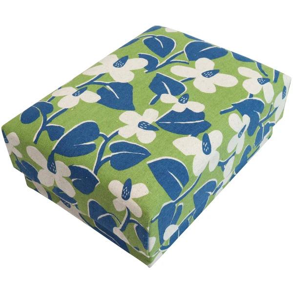 A rectangular box with a floral pattern in shades of green and blue.