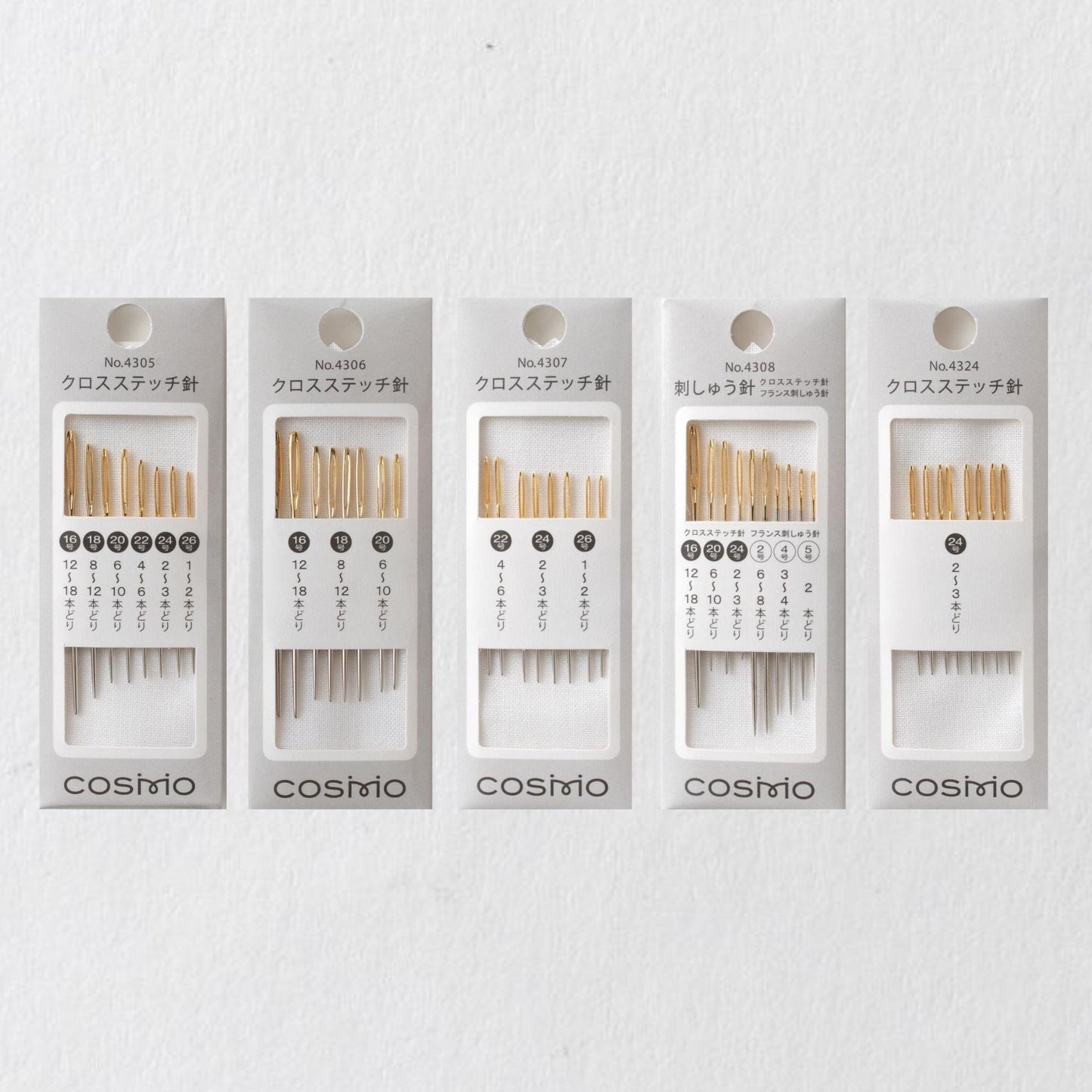 a collection of five packages of knitting needles, each with a different number of needles inside.