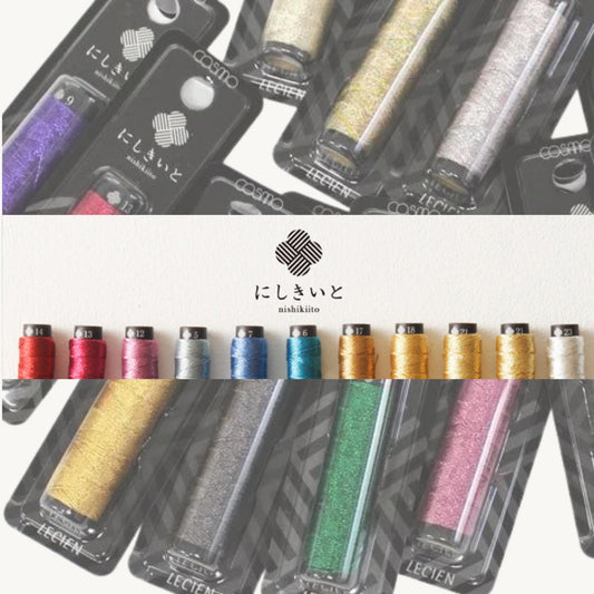 a variety of colorful spools of thread, including metallic and glittery threads, arranged in rows. The spools are displayed in packaging, and there is a logo or branding visible in the image.