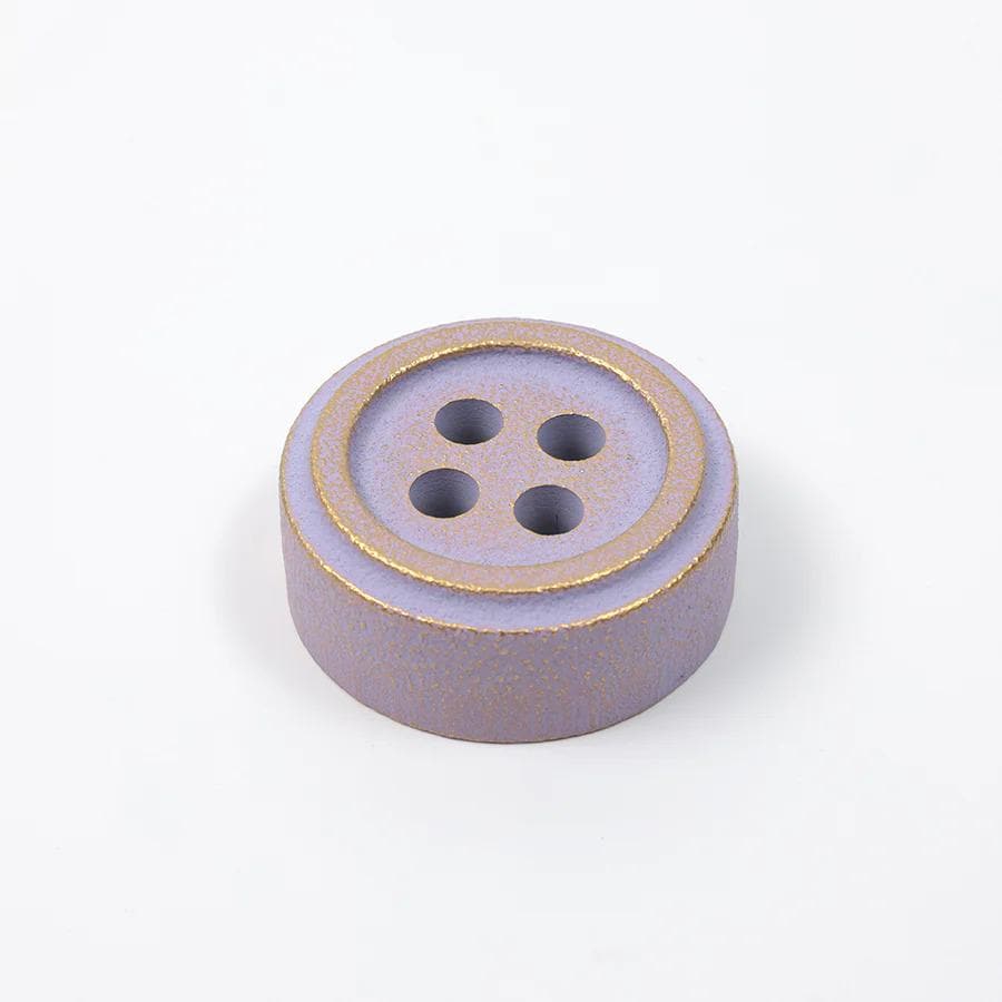 A purple button with gold trim is shown against a white background.