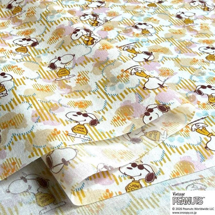 a repeating pattern of cartoon characters, likely from the Peanuts comic strip, on a fabric or paper.