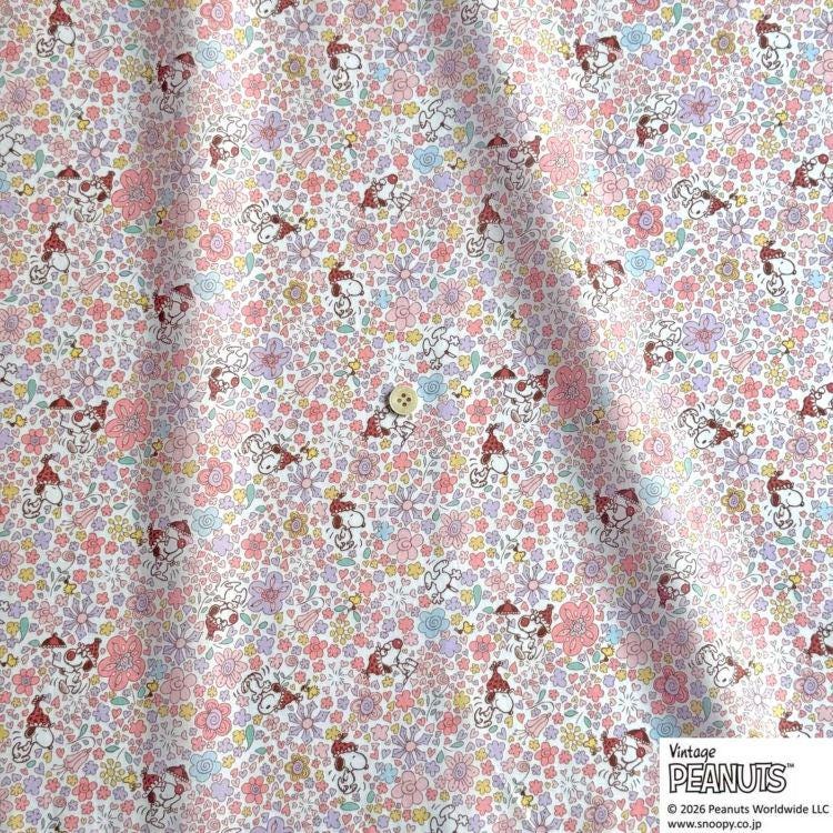 The image is a fabric with a repeating pattern of cartoon characters, specifically the Peanuts characters, printed on it. The pattern consists of various Peanuts characters in different poses and expressions, creating a lively and colorful design.