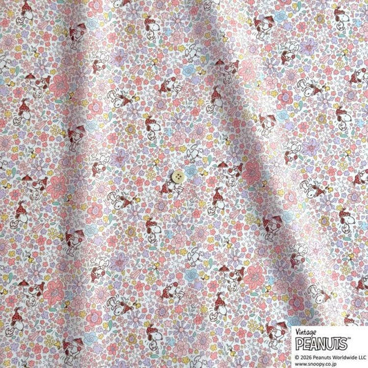 The image is a fabric with a repeating pattern of cartoon characters, specifically the Peanuts characters, printed on it. The pattern consists of various Peanuts characters in different poses and expressions, creating a lively and colorful design.