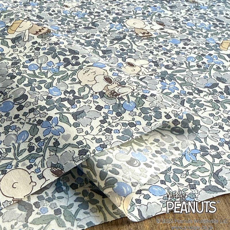 a close-up view of a fabric with a floral pattern, including the iconic Peanuts characters.