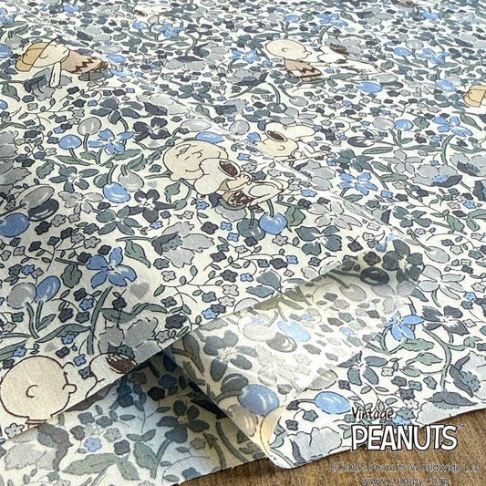 a close-up view of a fabric with a floral pattern, including the iconic Peanuts characters.